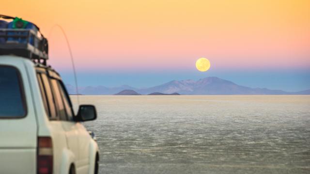 Drive over salt flats at sunrise