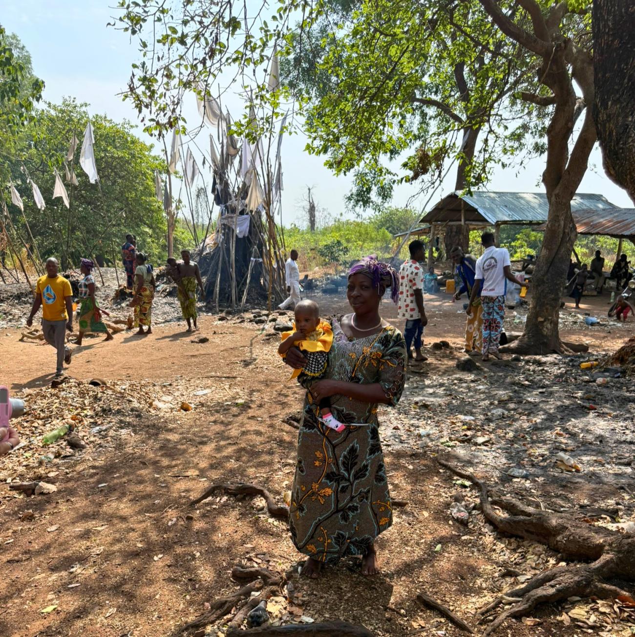 Photo of woman holding a child at Dankoli Voodoo Temple in Benin