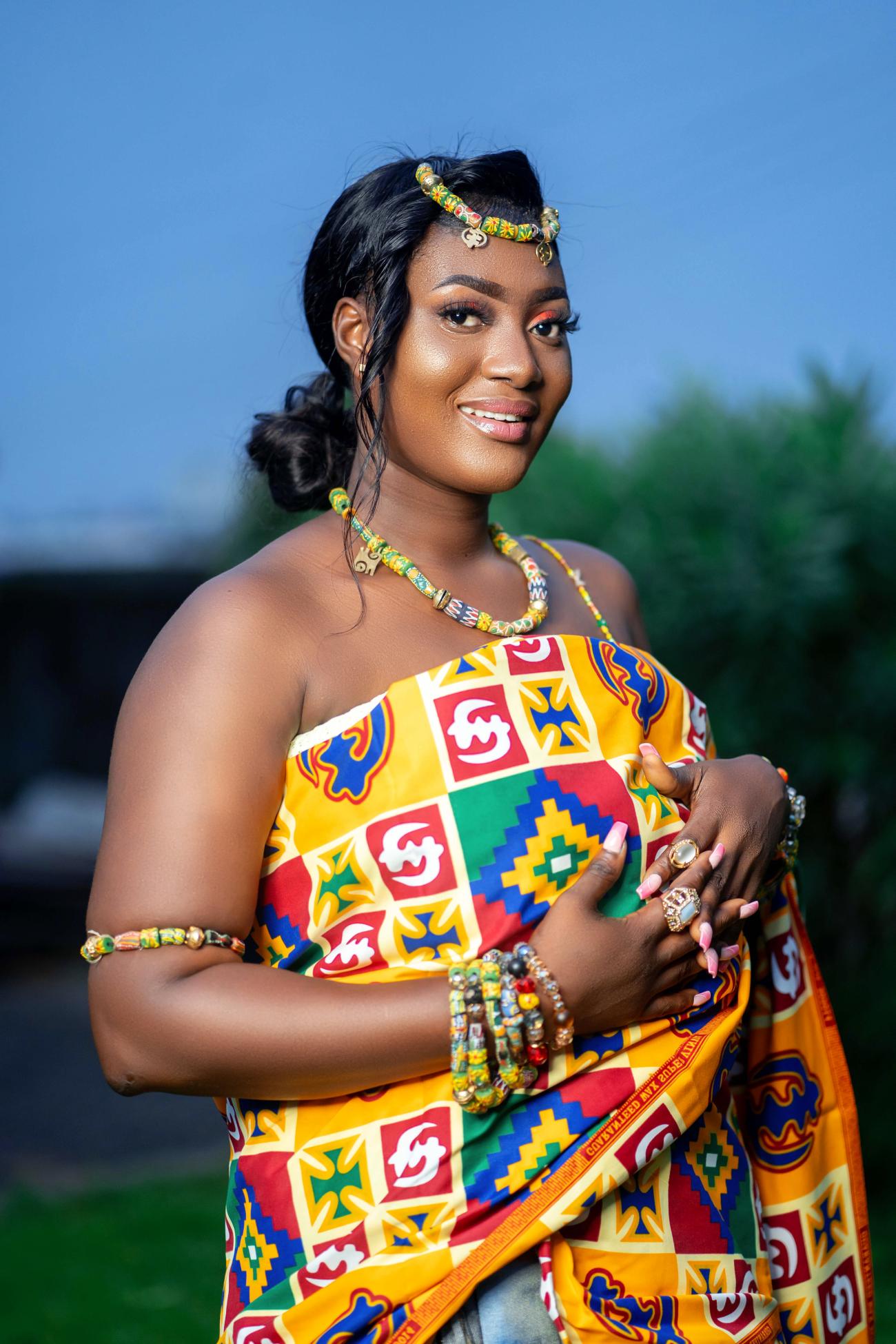 Woman wearing traditional Ghanaian outfit made from kente cloth