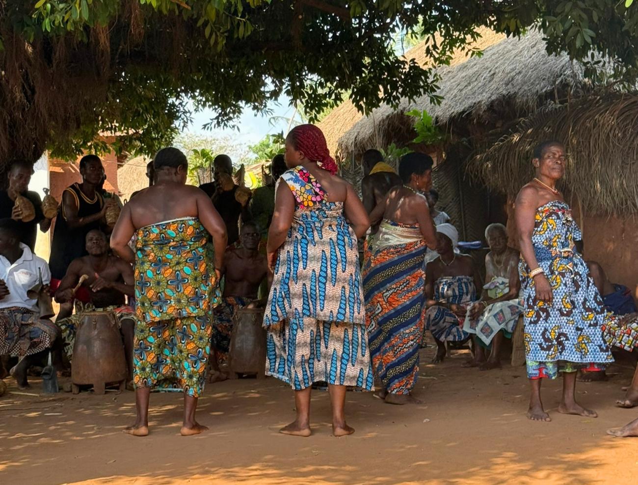 Women in traditional waxprint dresses at Ouidah Festival 